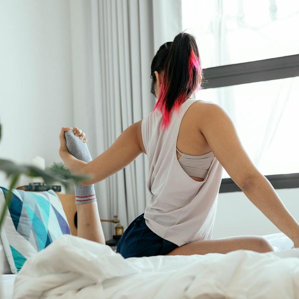 Woman performing a fluid yoga pose in the morning light.
